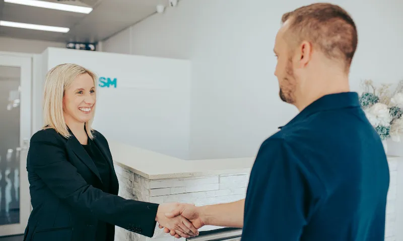 Woman shaking hands with client