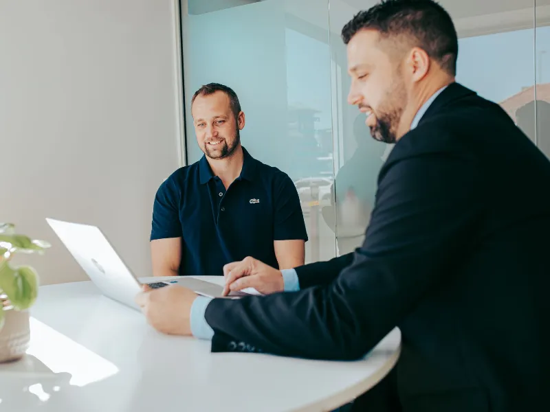 Manager explaining to a client showing laptop