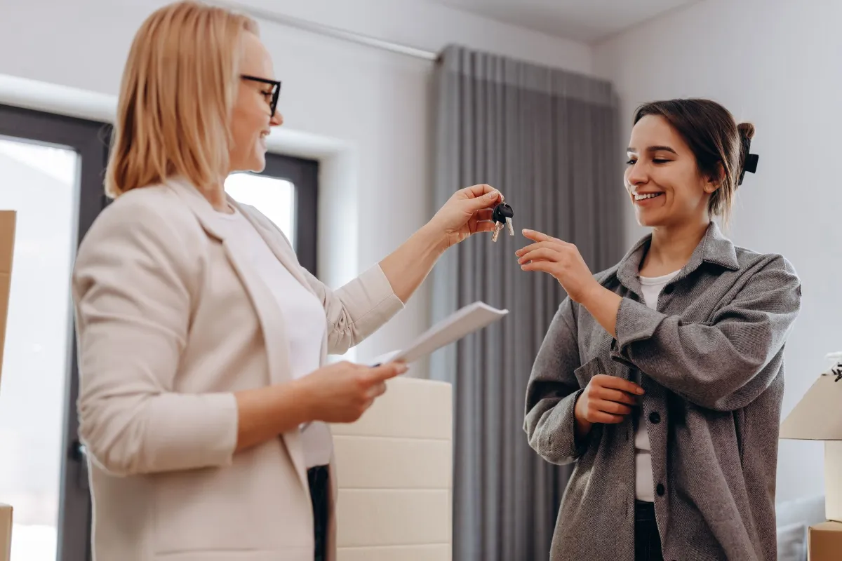 ASSM - Rules of renting a strata property Women getting a key for her rental house